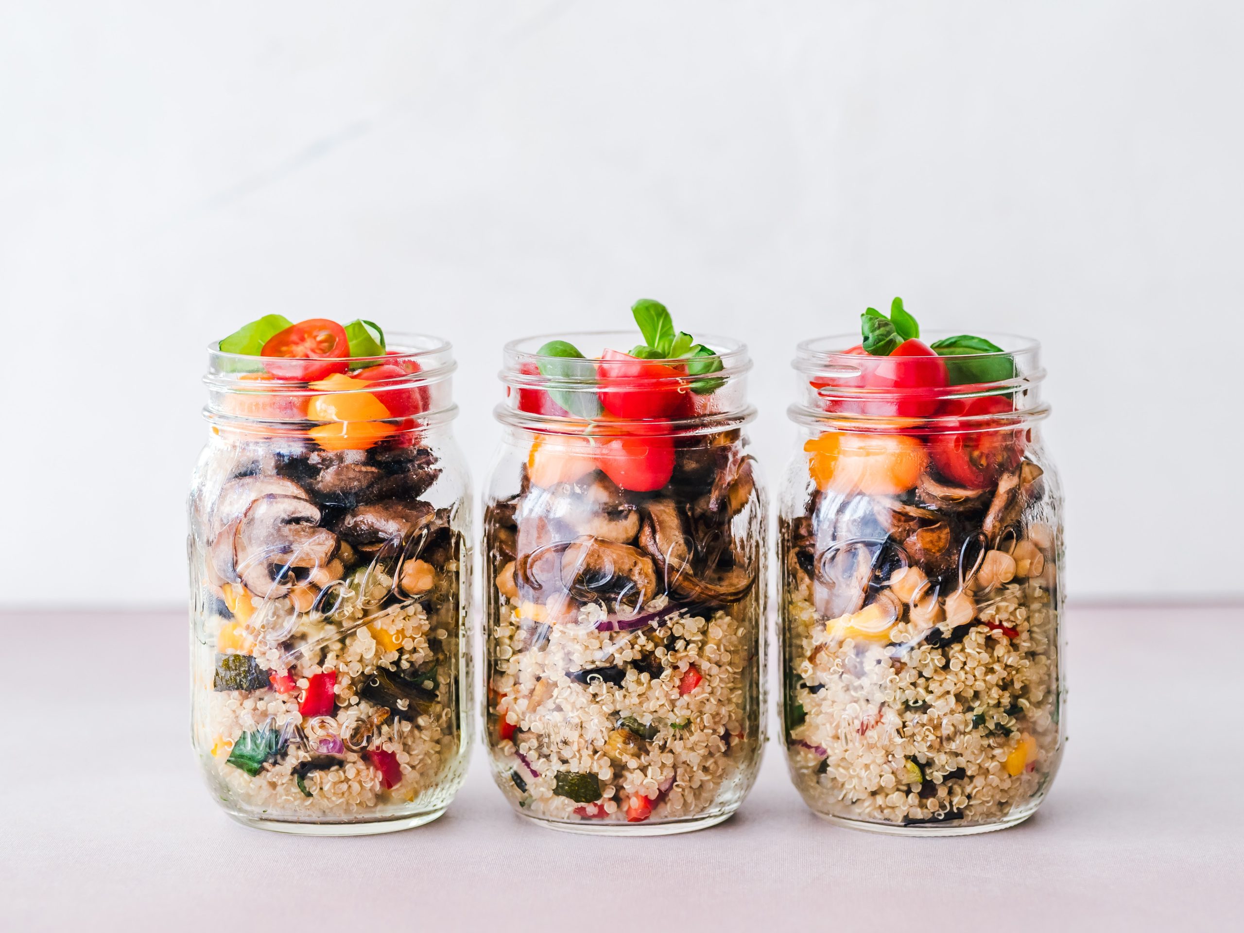 A variety of colorful meal prep containers filled with neatly arranged, portioned meals. Fresh ingredients and vibrant colors signify healthy and convenient meal prepping made easy