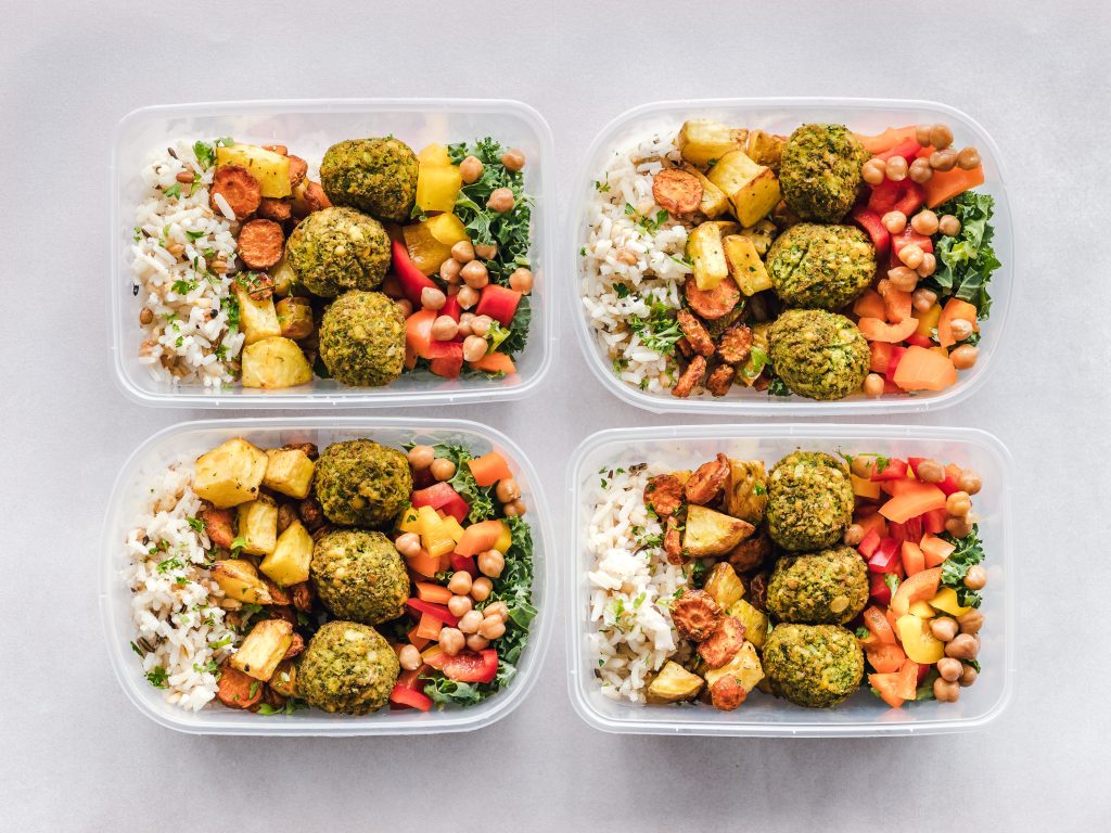 A colorful image featuring a beginner-friendly meal prep setup with various ingredients, containers, and utensils. The image represents the concept of meal prepping for beginners, providing step-by-step guidance and inspiration for organized and healthy meal preparation