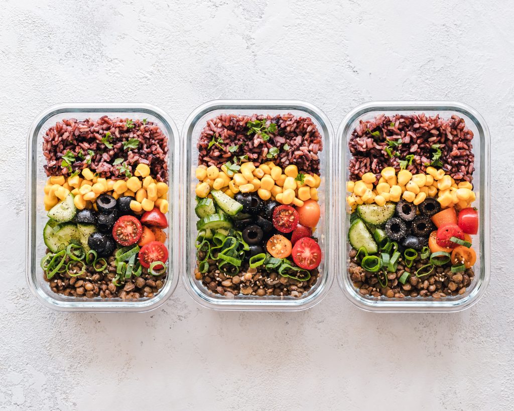 A visually appealing image showcasing a variety of colorful meal prep containers filled with nutritious meals. The image represents the ultimate guide to meal prepping, providing practical tips and strategies for busy individuals."